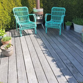 Accoya Color Gray Decking with green chairs far - square