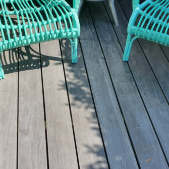 Accoya Color Gray Decking with green chairs - wide