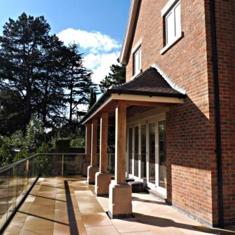 Tutbury bifold door 6 six panel painted strutt yellow clear glass closed external view Oak canopy roof brick building